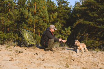 Tourist have break with dog and backpack