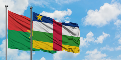Burkina Faso and Central African Republic flag waving in the wind against white cloudy blue sky together. Diplomacy concept, international relations.
