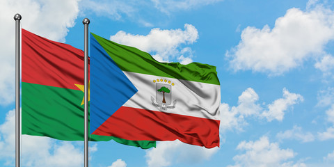 Burkina Faso and Equatorial Guinea flag waving in the wind against white cloudy blue sky together. Diplomacy concept, international relations.