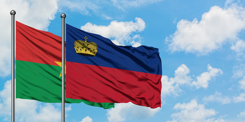Burkina Faso and Liechtenstein flag waving in the wind against white cloudy blue sky together. Diplomacy concept, international relations.