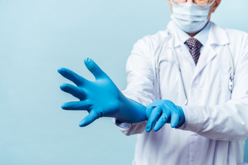 doctor puts on rubber gloves, healthcare and medicine.