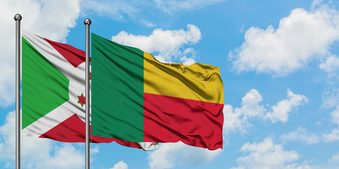 Burundi and Benin flag waving in the wind against white cloudy blue sky together. Diplomacy concept, international relations.