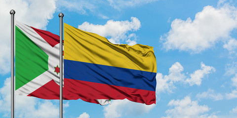 Burundi and Colombia flag waving in the wind against white cloudy blue sky together. Diplomacy concept, international relations.