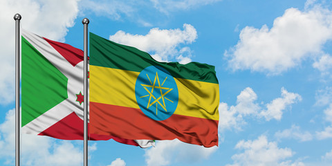 Burundi and Ethiopia flag waving in the wind against white cloudy blue sky together. Diplomacy concept, international relations.