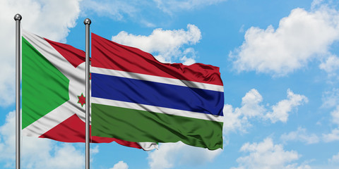 Burundi and Gambia flag waving in the wind against white cloudy blue sky together. Diplomacy concept, international relations.