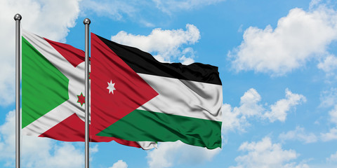 Burundi and Jordan flag waving in the wind against white cloudy blue sky together. Diplomacy concept, international relations.
