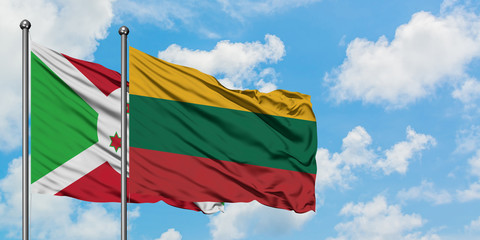 Burundi and Lithuania flag waving in the wind against white cloudy blue sky together. Diplomacy concept, international relations.