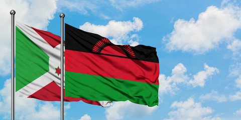 Burundi and Malawi flag waving in the wind against white cloudy blue sky together. Diplomacy concept, international relations.