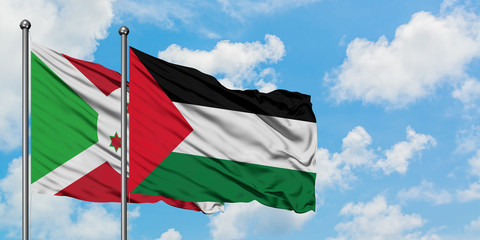 Burundi and Palestine flag waving in the wind against white cloudy blue sky together. Diplomacy concept, international relations.