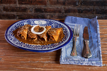 Mole enchiladas traditional mexican gastronomy in a talavera plate