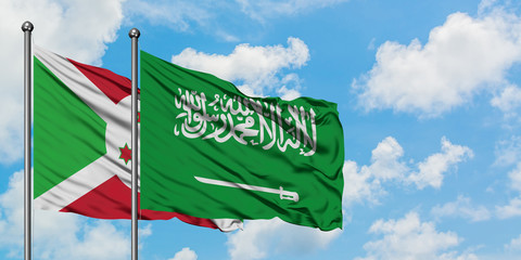 Burundi and Saudi Arabia flag waving in the wind against white cloudy blue sky together. Diplomacy concept, international relations.