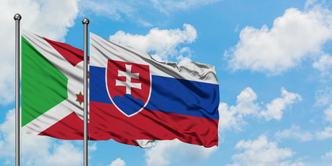Burundi and Slovakia flag waving in the wind against white cloudy blue sky together. Diplomacy concept, international relations.