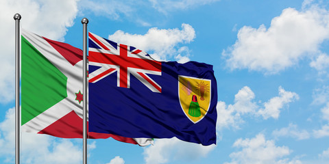 Burundi and Turks And Caicos Islands flag waving in the wind against white cloudy blue sky together. Diplomacy concept, international relations.