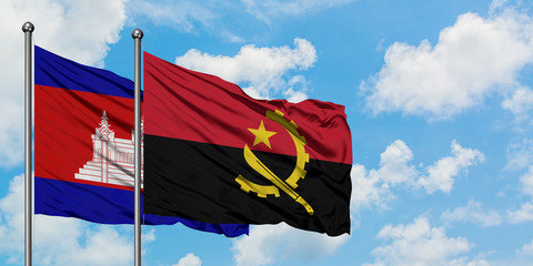 Cambodia and Angola flag waving in the wind against white cloudy blue sky together. Diplomacy concept, international relations.