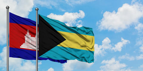 Cambodia and Bahamas flag waving in the wind against white cloudy blue sky together. Diplomacy concept, international relations.