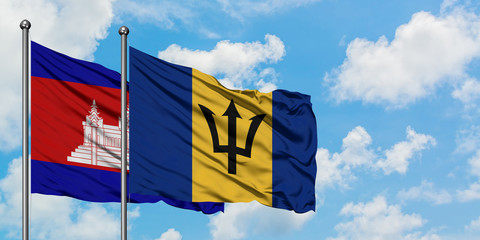 Cambodia and Barbados flag waving in the wind against white cloudy blue sky together. Diplomacy concept, international relations.
