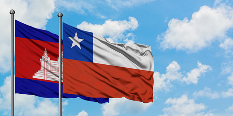 Cambodia and Chile flag waving in the wind against white cloudy blue sky together. Diplomacy concept, international relations.