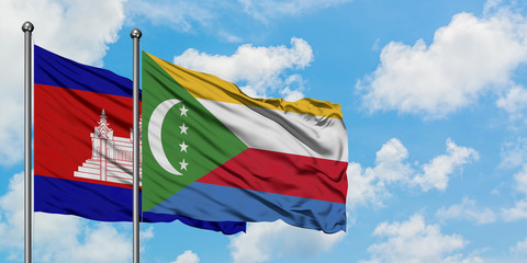 Cambodia and Comoros flag waving in the wind against white cloudy blue sky together. Diplomacy concept, international relations.