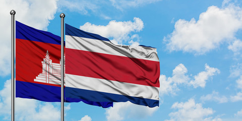 Cambodia and Costa Rica flag waving in the wind against white cloudy blue sky together. Diplomacy concept, international relations.