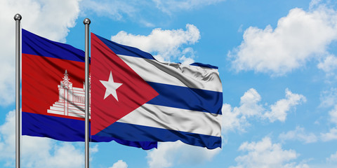 Cambodia and Cuba flag waving in the wind against white cloudy blue sky together. Diplomacy concept, international relations.