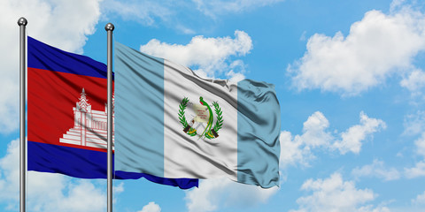 Cambodia and Guatemala flag waving in the wind against white cloudy blue sky together. Diplomacy concept, international relations.