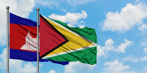 Cambodia and Guyana flag waving in the wind against white cloudy blue sky together. Diplomacy concept, international relations.