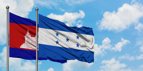 Cambodia and Honduras flag waving in the wind against white cloudy blue sky together. Diplomacy concept, international relations.