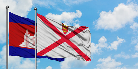 Cambodia and Jersey flag waving in the wind against white cloudy blue sky together. Diplomacy concept, international relations.