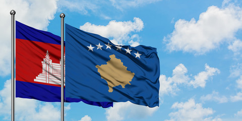 Cambodia and Kosovo flag waving in the wind against white cloudy blue sky together. Diplomacy concept, international relations.