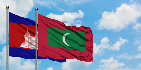 Cambodia and Maldives flag waving in the wind against white cloudy blue sky together. Diplomacy concept, international relations.