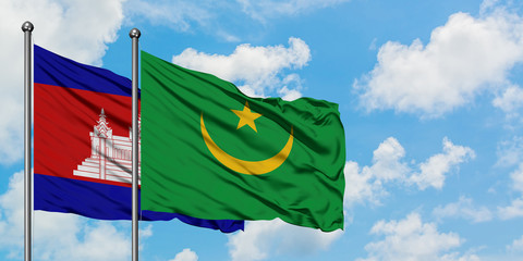 Cambodia and Mauritania flag waving in the wind against white cloudy blue sky together. Diplomacy concept, international relations.