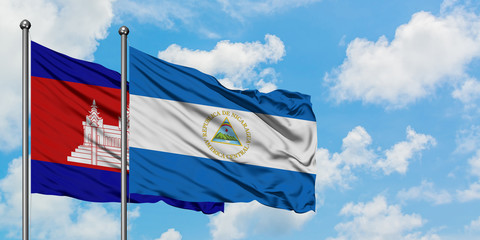 Cambodia and Nicaragua flag waving in the wind against white cloudy blue sky together. Diplomacy concept, international relations.