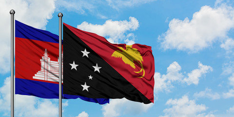 Cambodia and Papua New Guinea flag waving in the wind against white cloudy blue sky together. Diplomacy concept, international relations.
