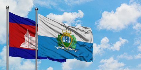 Cambodia and San Marino flag waving in the wind against white cloudy blue sky together. Diplomacy concept, international relations.