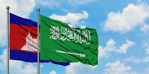 Cambodia and Saudi Arabia flag waving in the wind against white cloudy blue sky together. Diplomacy concept, international relations.