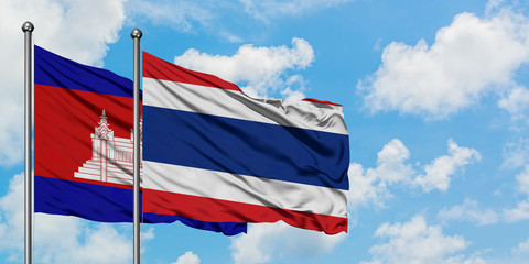 Cambodia and Thailand flag waving in the wind against white cloudy blue sky together. Diplomacy concept, international relations.