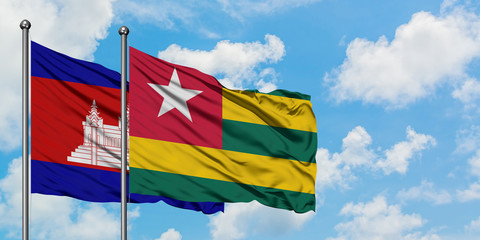 Cambodia and Togo flag waving in the wind against white cloudy blue sky together. Diplomacy concept, international relations.