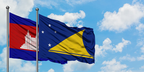 Cambodia and Tokelau flag waving in the wind against white cloudy blue sky together. Diplomacy concept, international relations.