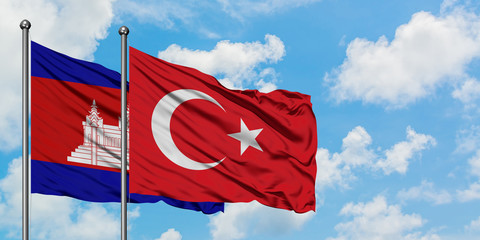 Cambodia and Turkey flag waving in the wind against white cloudy blue sky together. Diplomacy concept, international relations.