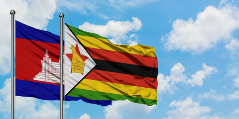 Cambodia and Zimbabwe flag waving in the wind against white cloudy blue sky together. Diplomacy concept, international relations.