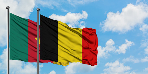 Cameroon and Belgium flag waving in the wind against white cloudy blue sky together. Diplomacy concept, international relations.