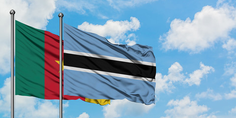 Cameroon and Botswana flag waving in the wind against white cloudy blue sky together. Diplomacy concept, international relations.