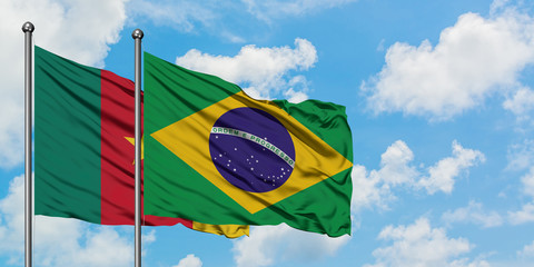 Cameroon and Brazil flag waving in the wind against white cloudy blue sky together. Diplomacy concept, international relations.