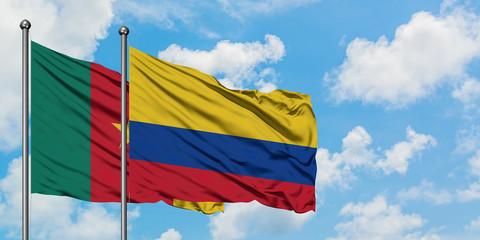 Cameroon and Colombia flag waving in the wind against white cloudy blue sky together. Diplomacy concept, international relations.