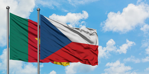 Cameroon and Czech Republic flag waving in the wind against white cloudy blue sky together. Diplomacy concept, international relations.