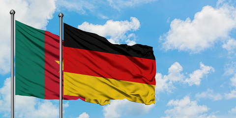 Cameroon and Germany flag waving in the wind against white cloudy blue sky together. Diplomacy concept, international relations.