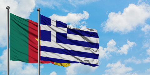 Cameroon and Greece flag waving in the wind against white cloudy blue sky together. Diplomacy concept, international relations.