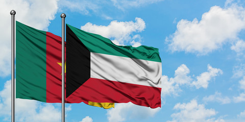 Cameroon and Kuwait flag waving in the wind against white cloudy blue sky together. Diplomacy concept, international relations.