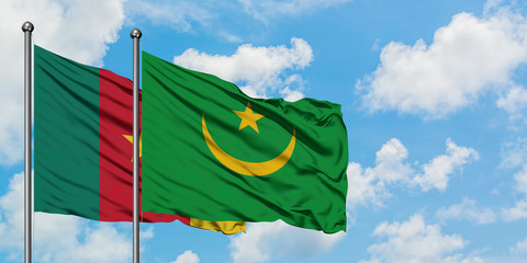 Cameroon and Mauritania flag waving in the wind against white cloudy blue sky together. Diplomacy concept, international relations.
