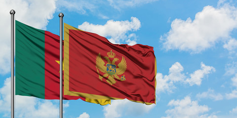 Cameroon and Montenegro flag waving in the wind against white cloudy blue sky together. Diplomacy concept, international relations.